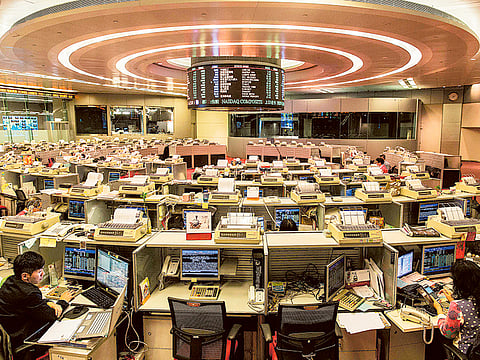 Traders at the stock exchange in Hong Kong. Asian investors traded cautiously Wednesday July 22, 2020, after the previous day's strong rally, with optimism over a possible vaccine tempered by profit-taking and concerns about the slow progress being made by US lawmakers in drafting a new stimulus package.