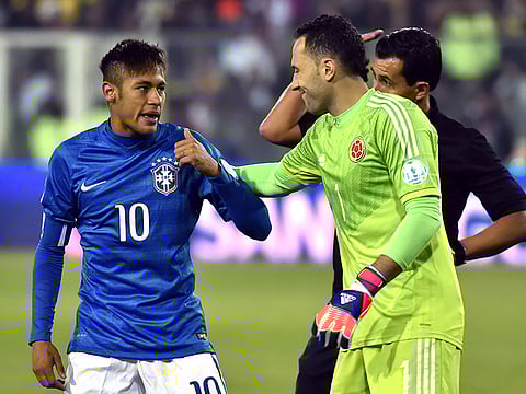 Brazilian star Neymar(L) talks to Colomboan goalie David Ospina(2R) during their Copa America football match at the Estadio Monumental David Arellano in Santiago, Chile, on June 17, 2015.