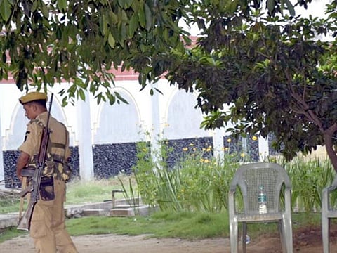 A police officer stands guard in Patna.