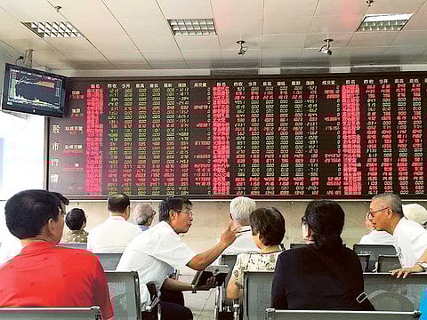 A brokerage house in Beijing. Asian investors, spooked by a pandemic with seemingly no end in sight, are flocking to a growing segment of the mutual fund industry - income funds backed by corporate debt that pay out monthly.