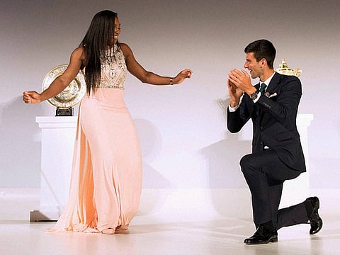 Wimbledon men’s and women’s singles champions
Novak Djokovic and Serena Williams dance on stage at
the Champions’ Dinner in central London.
