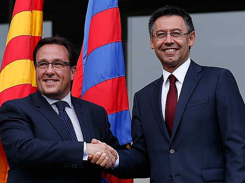 FC Barcelona president Josep Maria Bartomeu, right, shakes hands with management board member Ramon Adell after his election as president at the Camp Nou Stadium.