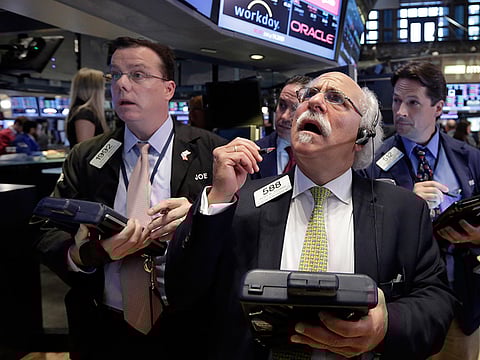Peter Tuchman, foreground right, works with fellow traders on the floor of the New York Stock Exchange, Monday, Aug. 24, 2015. U.S. stock markets plunged in early trading Monday following a big drop in Chinese stocks.