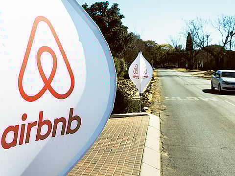 The logos of Airbnb Inc. sit on banners displayed outside a media event in Johannesburg, South Africa.