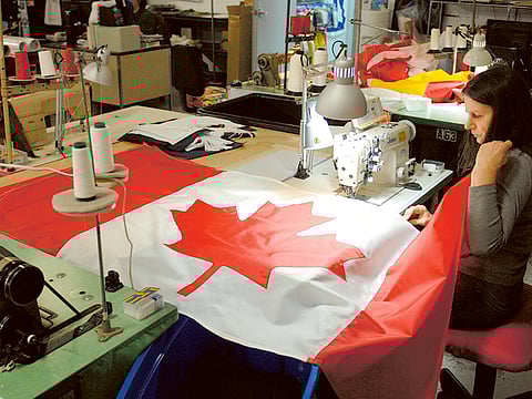 A woman makes a Canadian flag