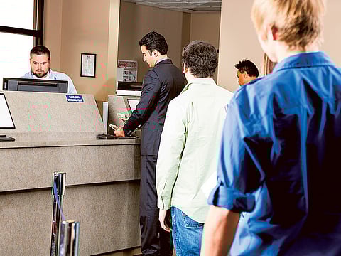 Customers waiting at a UAE bank branch. Over the past five years, total defaults by Indian borrowers in the UAE is estimated in excess of Dh26 billion (Rs500 billion).