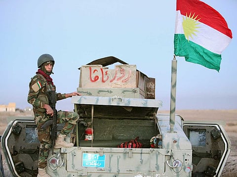 File picture: A member of Peshmerga forces stands on a military vehicle in Iraq.
