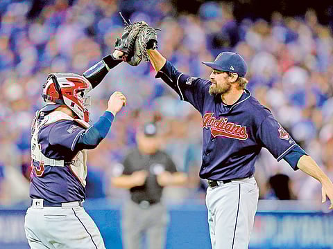 Andrew Miller (right) of the Cleveland Indians celebrates with teammate Roberto Perez