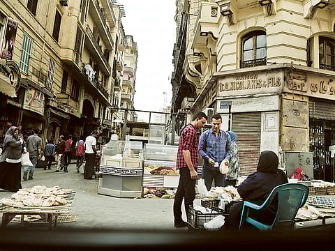 A woman sells bread in downtown Cairo. Despite the pandemic and tourism collapse, Egypt is projecting healthy economic growth this year, even as one third of the Arab world’s most populous country remains mired in poverty.