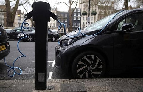 Electric cars are plugged into a charging point in London, Britain, April 7, 2016.