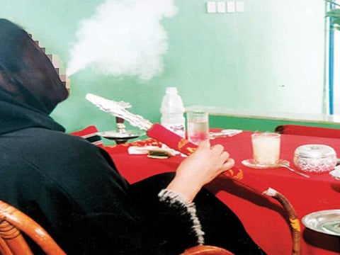 Picture for illustrative purposes only. A woman smoking shisha.