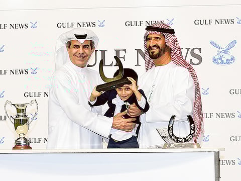 Ali Rashid Al Rayhi (right) receives the winner's trophy from Mohammed Almezel, Editor-at-Large, Gulf News after winning a Dubai World Cup Carnival race.