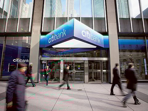 Pedestrians walk past a Citibank branch located adjacent to Citigroup Inc. headquarters in New York. US consumers increased their borrowing in September, helped by the first gain in the category that covers credit cards in seven months.