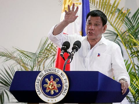 President Rodrigo Duterte gestures while answering questions during a news conference.