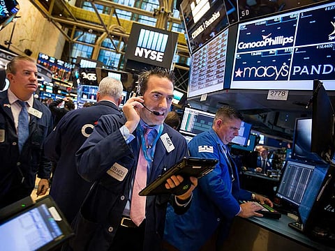Traders work on the floor of the New York Stock Exchange. With uncertainties regarding US elections fading, some investors expect company earnings and economic data to play a greater role in moving stock prices this year.