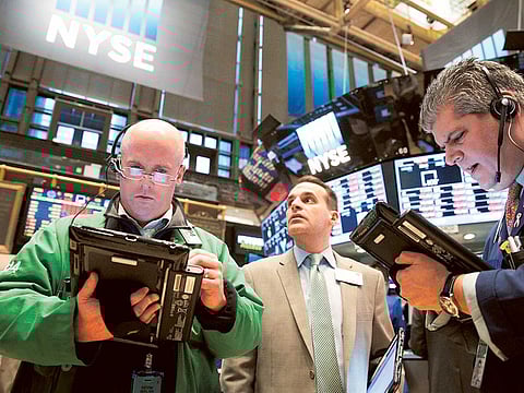 Traders work on the floor of the New York Stock Exchange (NYSE). Global stock markets are expected to stay pressured this week, as investors weigh a lack of urgency surrounding US monetary policy, await cues pertaining to the coronavirus vaccine trials and rising infection rates in several countries worldwide.