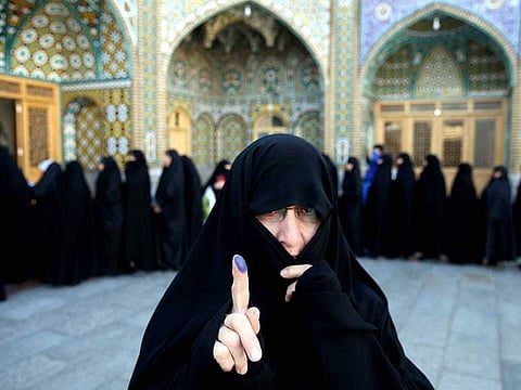 An Iranian woman displays her ink-stained finger after voting in the parliamentary polls (File)