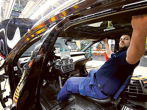 A Mercedes Benz employee work on a production line at the factory in Rastatt, Germany. Daimler AG unveiled a battery-powered counterpart to its top Mercedes-Benz luxury sedan as German carmakers ramp up their challenge to electric upstart Tesla.