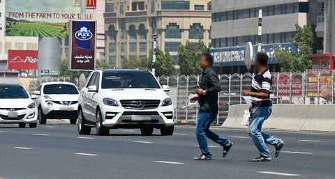 Jaywalkers are seen running across Al Ittihad Road in Sharjah.
