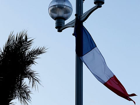 A street lamp in Paris decorated with the French flag