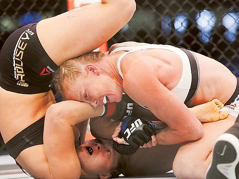 Holly Holm pins Ronda Rousey to the floor during their UFC fight in Melbourne