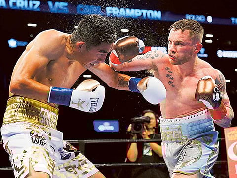 Carl Frampton lands a punch on Leo Santa Cruz during their WBA super world featherweight championship match.