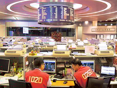 Traders on the floor of the Hong Kong Stock Exchange. Investors keep flocking to private equity in Asia even though returns are declining.