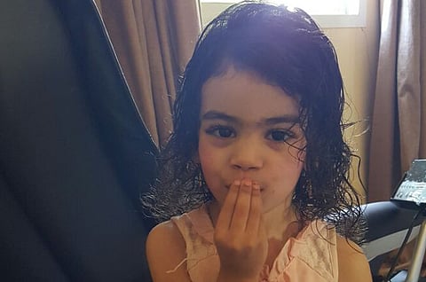 Girl rescued from burning car in critical condition