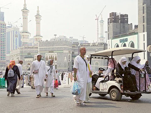 Muslim pilgrims walk at the Grand mosque in Mecca, Saudi Arabia.