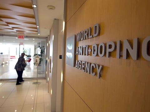 A woman walks into the head office of the World Anti-Doping Agency (WADA)