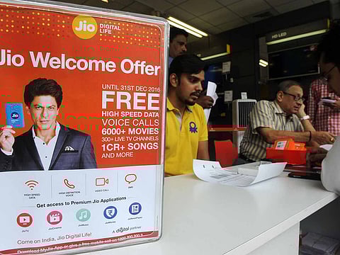 A customers wait to purchase Reliance Jio Infocomm 4G mobile service SIM cards at a store in Mumbai. Reports said three of the largest Middle Eastern sovereign wealth funds are in advanced talks to invest in Reliance Industries Ltd.'s digital arm