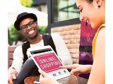 A woman shops online using a tablet. Picture used for illustrative purposes only.