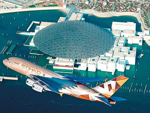An Etihad Airways Airbus A380 sporting the airline’s ‘Facets of Abu Dhabi’ livery conducts a
low-level fly-by of the Louvre Abu Dhabi during its opening.