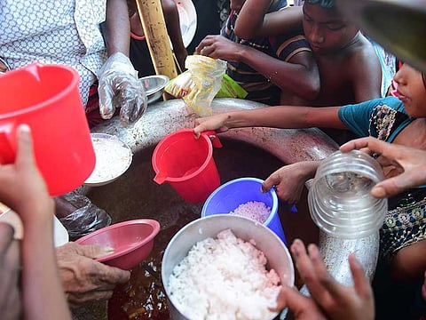 File photo: Rohingya refugee children receive food aid at Thankhali refugee camp in Bangladesh’s Ukhia district.
