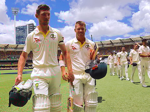 Australia's Cameron Bancroft walks off the field with David Warner
