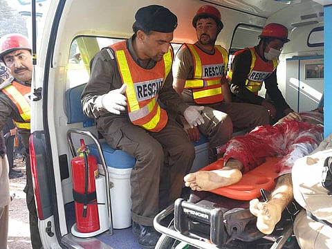 Rescue workers transport an injured person to the hospital after gunmen attacked the Directorate of Agriculture Institute in Peshawar. In latest attack, eight people died at the scene while one person later died in hospital.