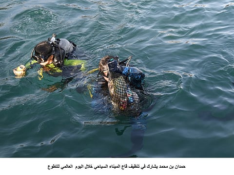 Hamdan, divers fish out trash on International Volunteer Day