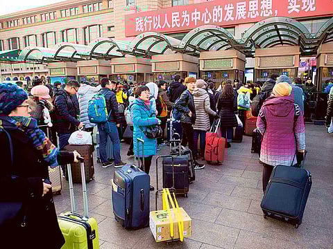 Passengers arrive at the train station. Oil is bearing the brunt of the anxiety due to the potential hit to travel, especially as it’s happening just before the Lunar New Year holidays
