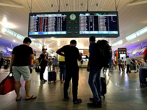Travelers are seen at the departure hall at Kuala Lumpur International Airport. Global passenger traffic will surpass pre-COVID 19 levels in 2023 amid a rapidly growing vaccinated population and advancements in testing.