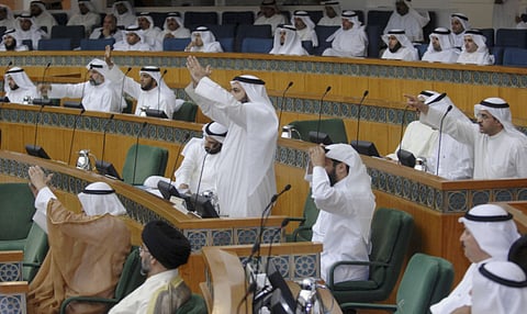 Members of Kuwait Parliament debate a bill in Kuwait National Assembly in a file picture. amnesty would cover “some Kuwaitis sentenced in past cases”