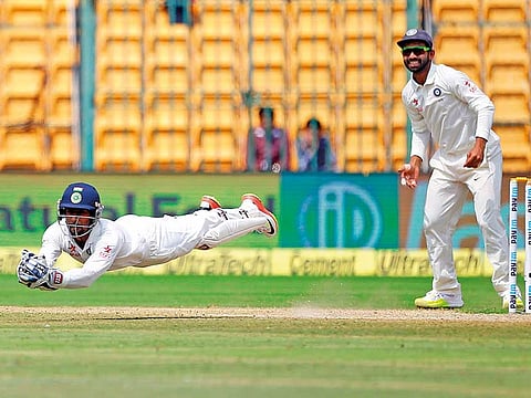 Wriddhiman Saha dives  to complete a spectacular catch to dismiss Australia’s Matthew Wade during India's home Test series in 2018.