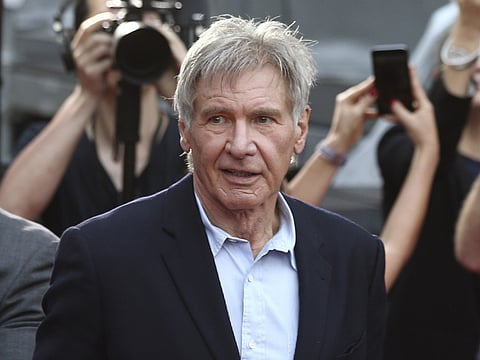 FILE - In this December 10, 2015 file photo, Harrison Ford greets fans during a Star Wars fan event in Sydney, Australia. Ford told an air traffic controller he was distracted and concerned about turbulence from another aircraft when he mistakenly landed his small plane on a taxiway at a Southern California airport last month. (AP Photo/Rob Griffith, File)