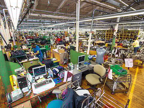 Employees on the production floor of a factory in Massachusetts. While investors and market spectators brace for the deepest global recession since World War II, there is reason for hope as economists now see the economic impasse ending in record time as well.