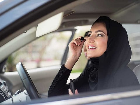 UAE drivers can get a Dh800 fine and four black points for applying make-up, styling hair, smoking shisha and using selfie-sticks.