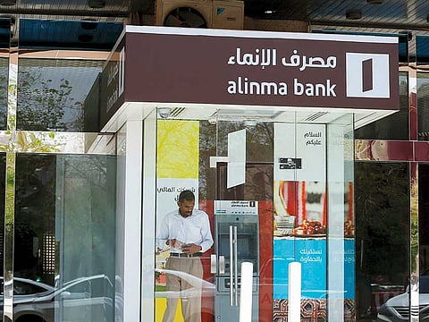 A man leaves an automated teller machine outside a bank in Riyadh. Saudi banks’ standalone credit profiles are likely to weaken as a result of the coronavirus and lower oil prices, despite the timely support measures introduced by the Saudi Arabian Monetary Authority, according to Fitch Ratings.