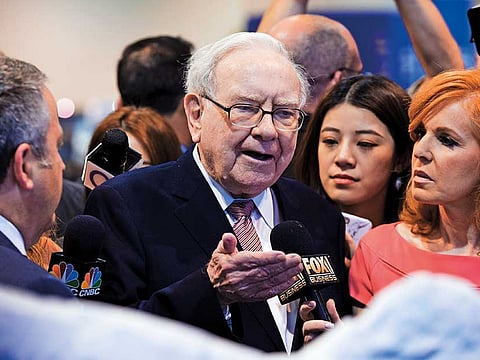 Warren Buffett speaks with journalists. Buffett’s Berkshire Hathaway Inc on Saturday posted a record net loss of nearly $50 billion as the coronavirus pandemic pummeled its common stock investments.