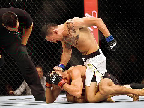 Max Holloway (top) of the United States in a killer mood against Jose Aldo of Brazil during their UFC featherweight bout last year.