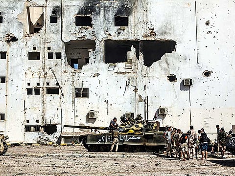 File picture shows tanks amid destroyed buildings in Sirte, Libya.