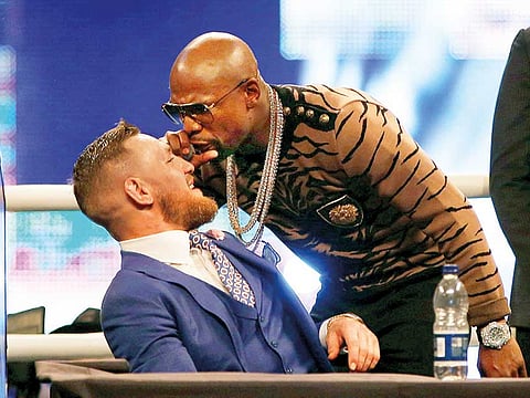 Floyd Mayweather (right) taunts Conor McGregor.