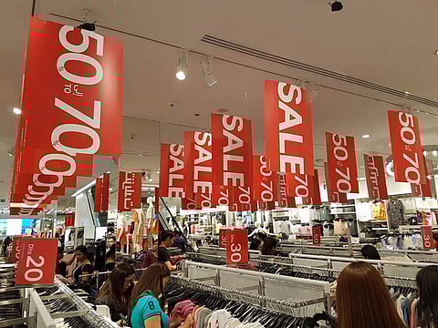 Red sale signs are plastered across different retail outlets in malls across Dubai, as the annual Dubai Summer Surprises is on.